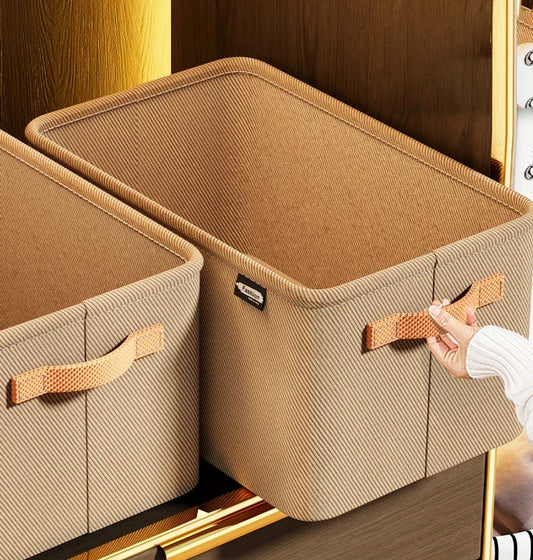 Beige storage bins with handles on a wooden shelf.
