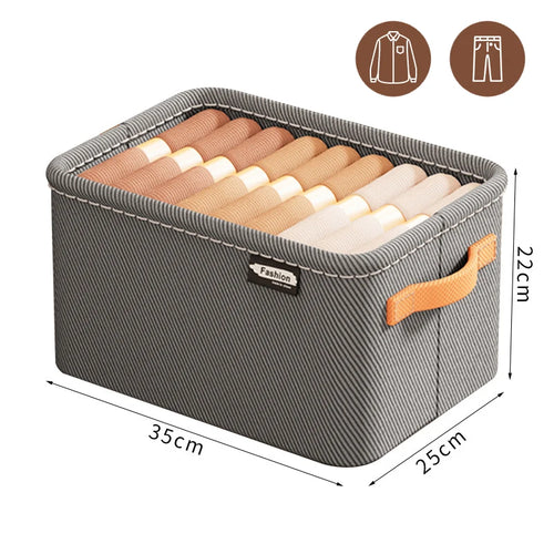 Gray storage box with brown handles containing folded clothes, labeled 'Fashion', with measurements on a white background.
