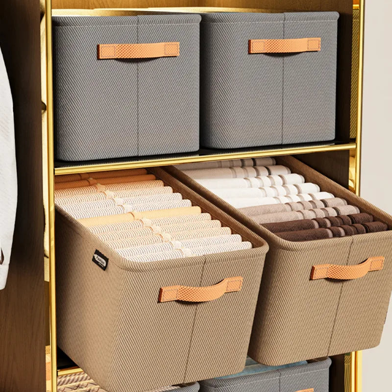 Storage bins with handles on a gold shelf
