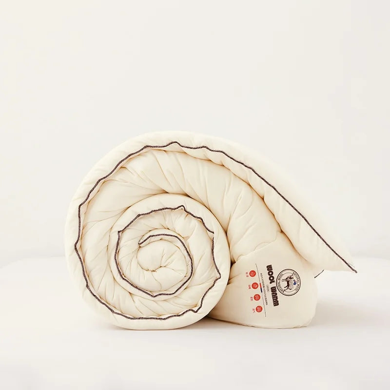 Rolled-up quilt with a brand logo on a light background